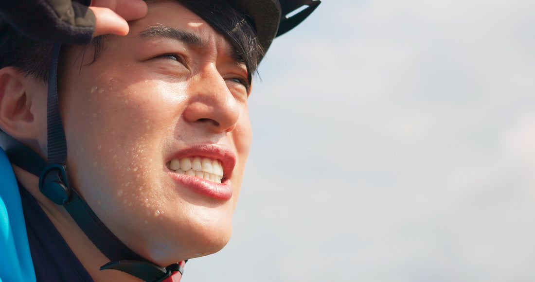 Asian male bike riding, sweating a lot.